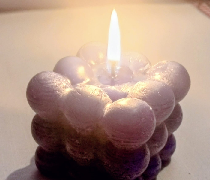 A Bubble Cube Candle burning